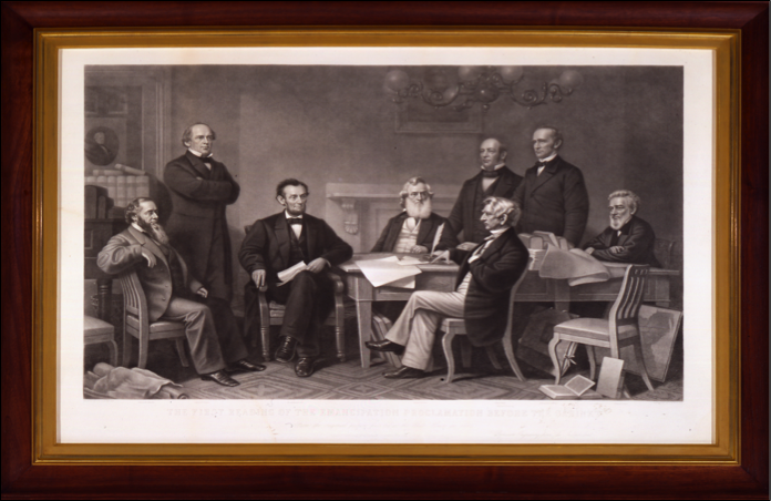 Framed black and white drawing of Abraham Lincoln and cabinet members sitting around a document.