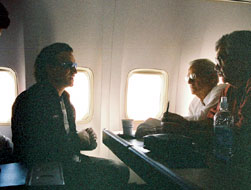 Secretary O'Neill, Bono, Undersecterary John Taylor (right) and Deputy Assistant Secretary Steve Radelet (left) discuss conclusions of the Africa trip on the return flight from Addis Ababa, Ethiopia.
