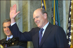 Treasury Secretary John Snow, waves to the audience after being sworn in as the 73rd Secretary of Treasury.
