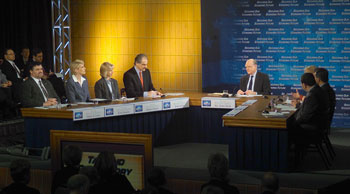 Photo: Secretary John Snow moderates a panel on tax and regulatory burden at the White House Conference on the Economy