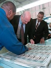 Photo: Secretary Paulson viewing the new currency with his signature.