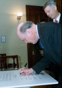 Secretary Snow signs Statement of Support while Bob Hollingsworth, 