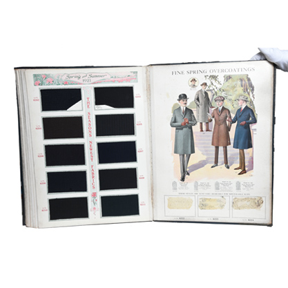 Color photograph of Edward Rose Company catalog. Displayed page reads "Fine Spring Overcoatings" and has a drawing of four men standing in overcoats.