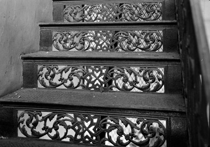 Black and white photograph of cast iron stairs.